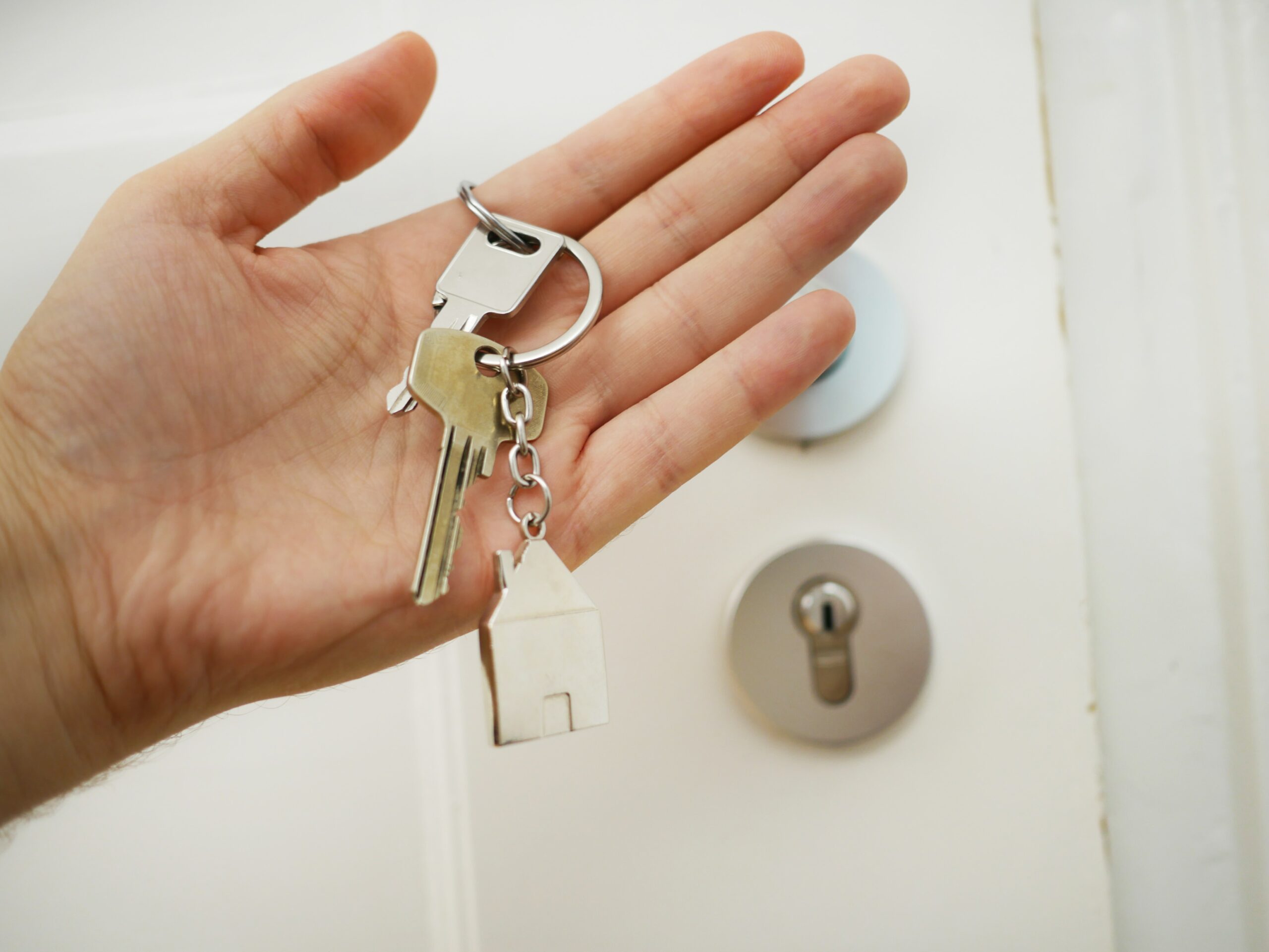 Real Estate Agent Handing Over Keys Because of Successful Real Estate Content Marketing