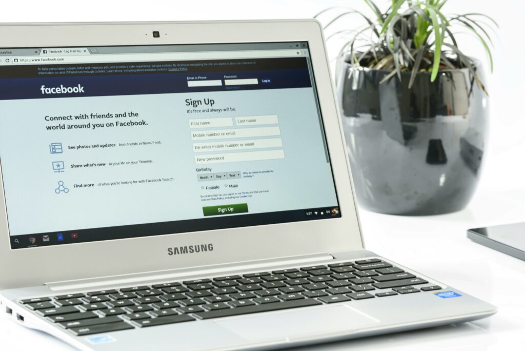Laptop displays Facebook login to see social media ads for realtors