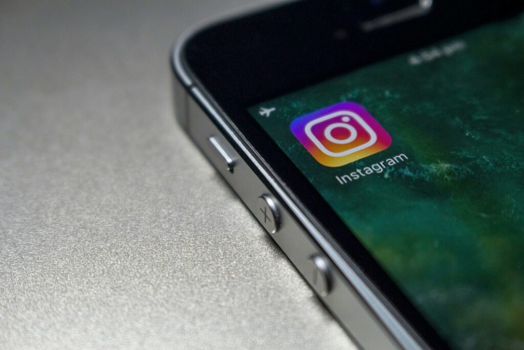 Instagram logo on a smart phone symbolizing real estate advertising on social media