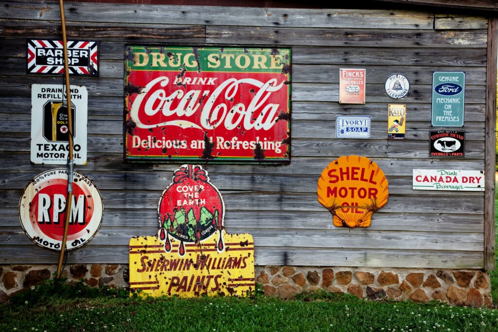 Vintage Coca Cola signage on a gray wooden wall
