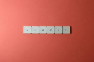 Wooden letter blocks spelling out the word "search" on a white background