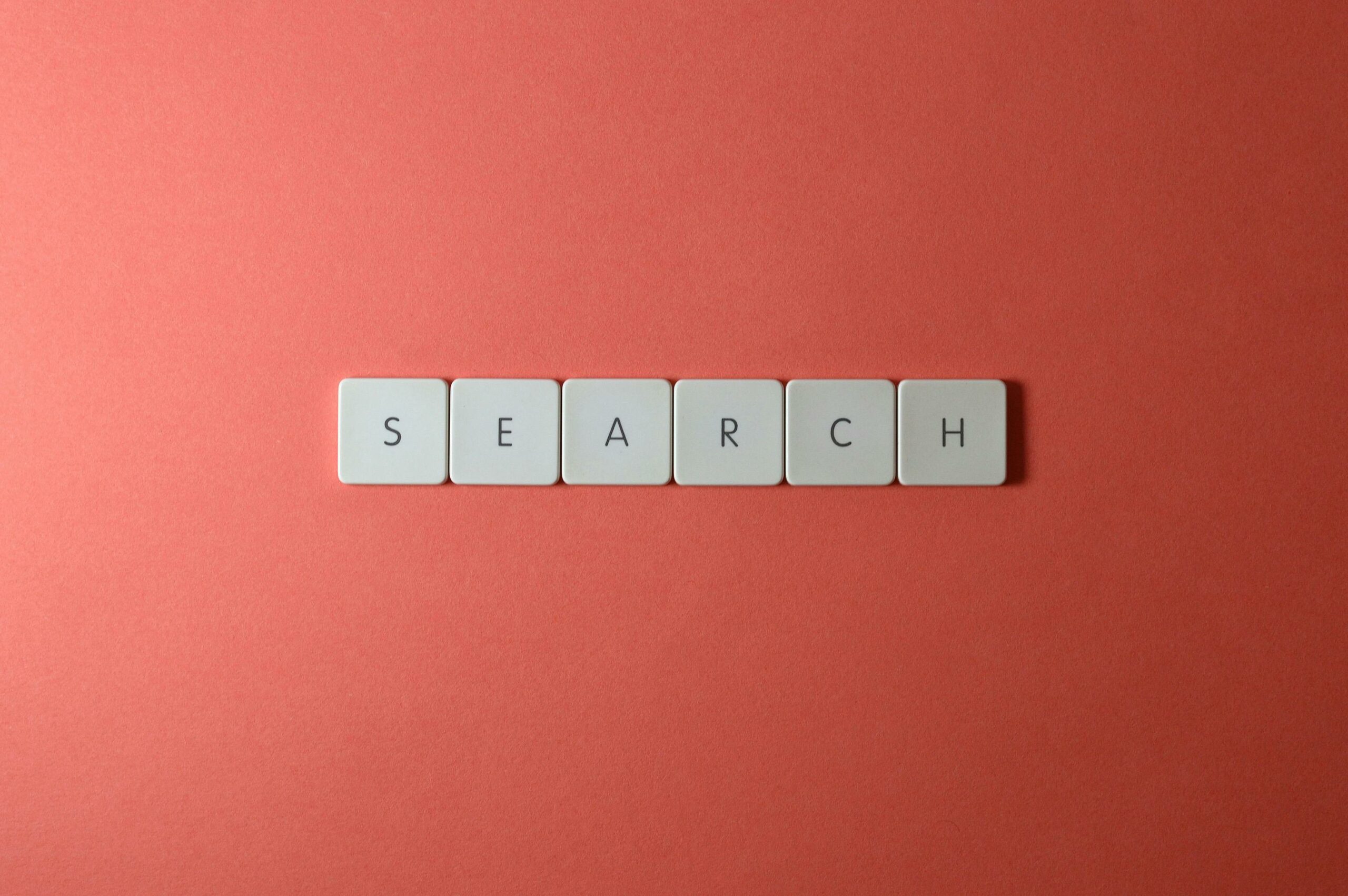 Wooden letter blocks spelling out the word "search" on a white background