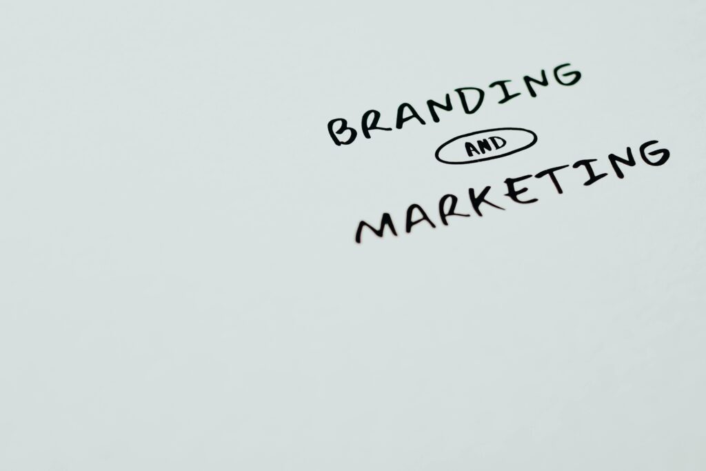 Whiteboard with scrawled “branding and marketing” on it, representing the importance of these in digital real estate advertising