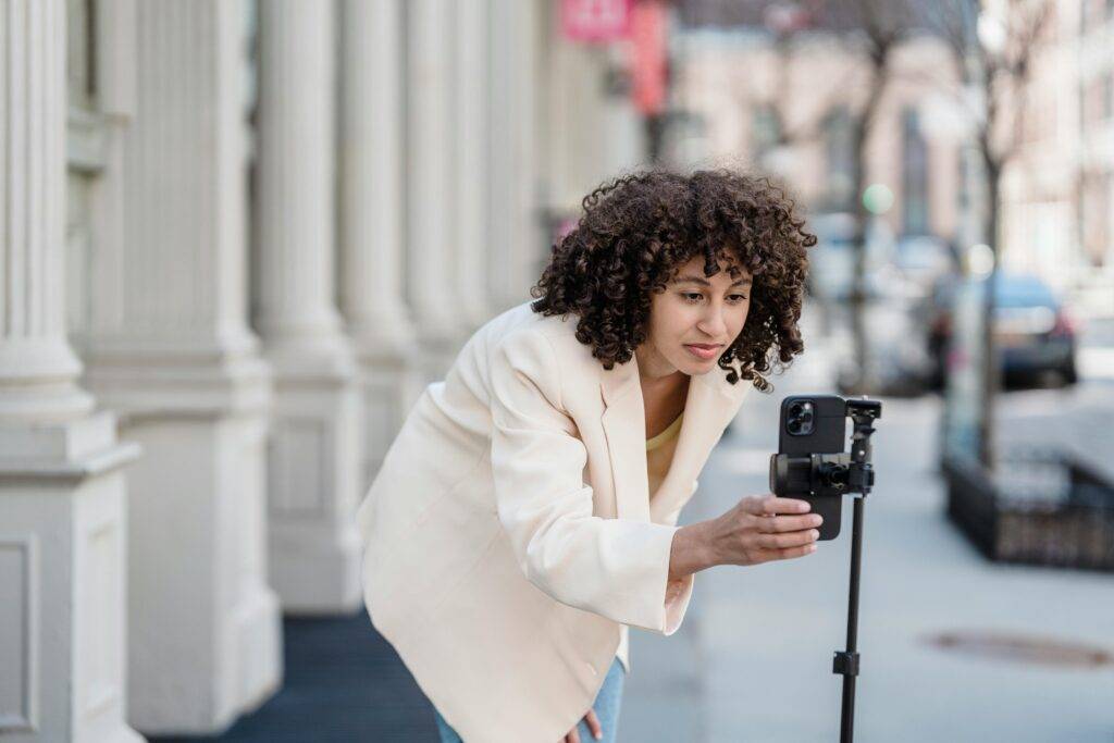 A real estate agent woman films a video on the street for social media advertising for Realtors and teams