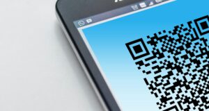 Smart phone displays a QR code representing advanced techniques and technology in advertising for real estate agents and teams by marketing company 23 Window Media