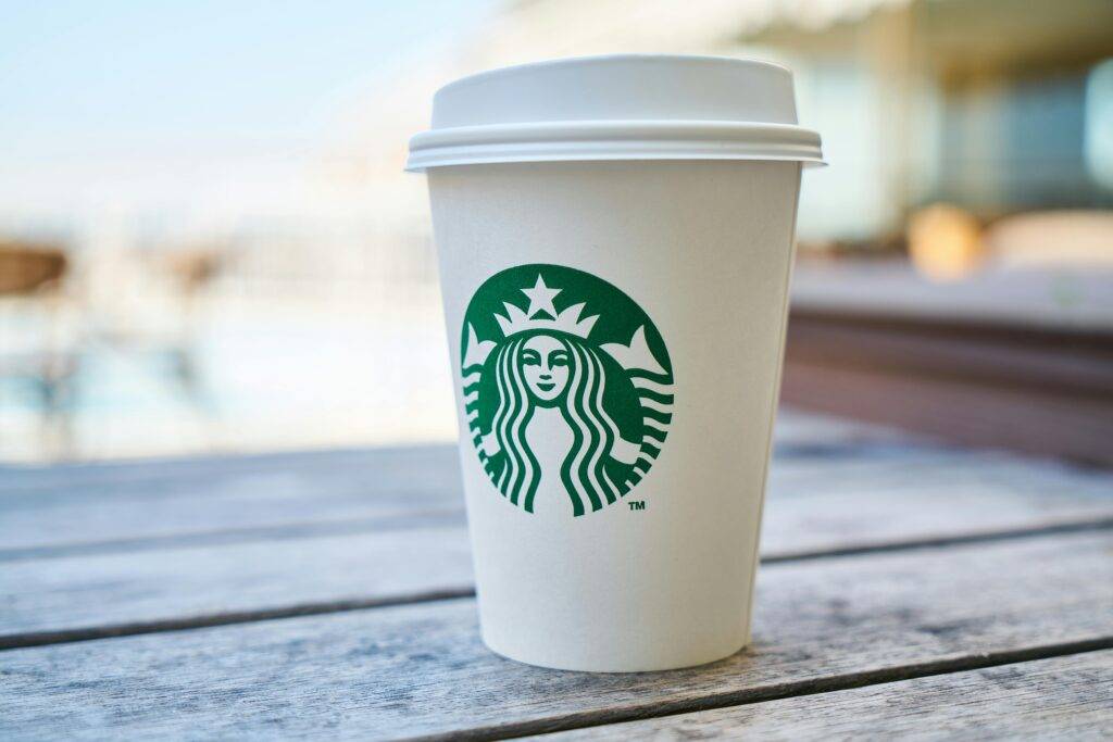 Starbucks cup with logo signifying the power of brand and branding for local real estate marketing success
