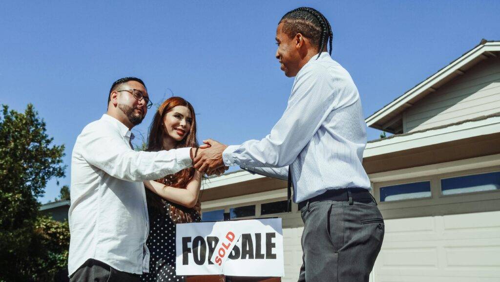 Man shakes hands with a Realtor after successful marketing and home sale
