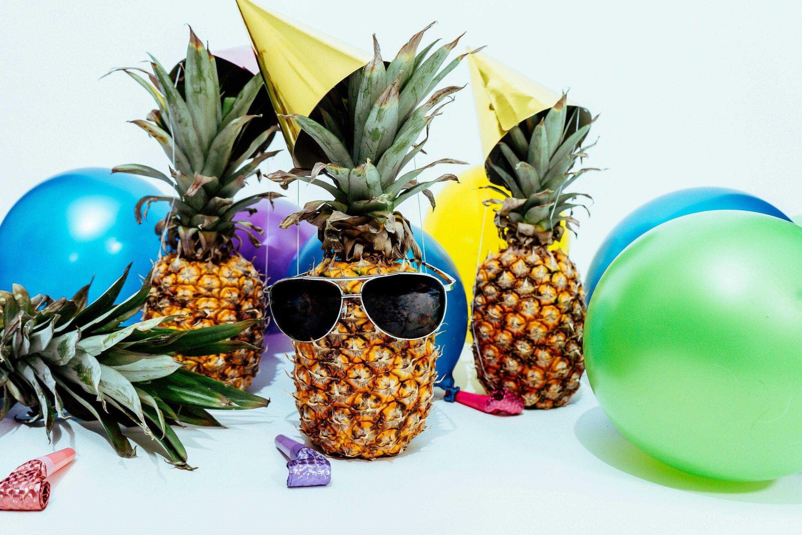 Pineapples dressed up like happy clients and raving fans celebrating together for real estate client referrals