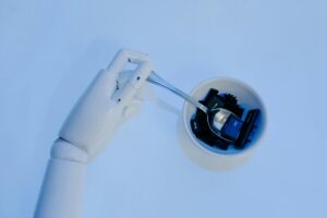 Robot hand holding a spoon to eat computer keycaps, representing AI in real estate marketing