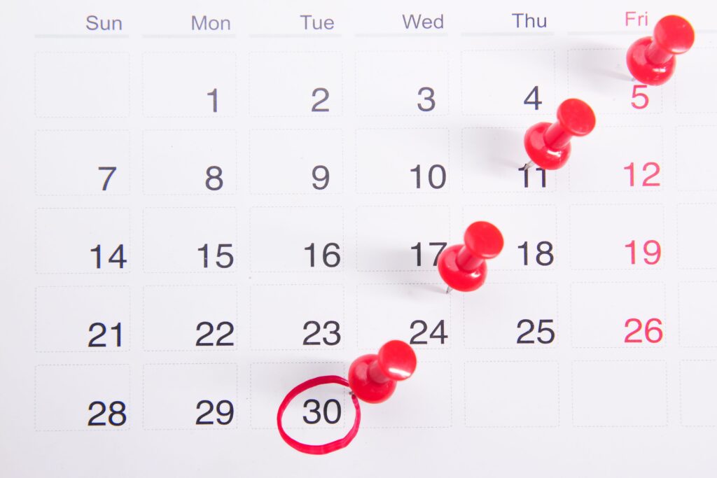 Wall calendar with dates marked for real estate marketing strategy plans in action.